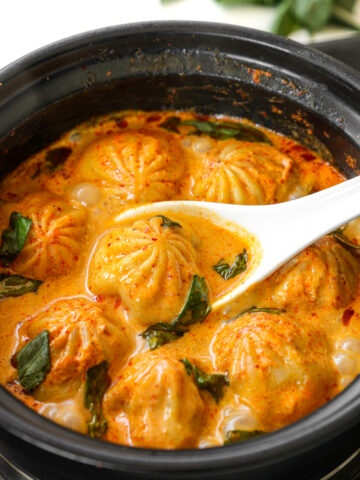 Soup dumplings in thai red curry sauce