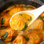 Soup dumplings in thai red curry sauce