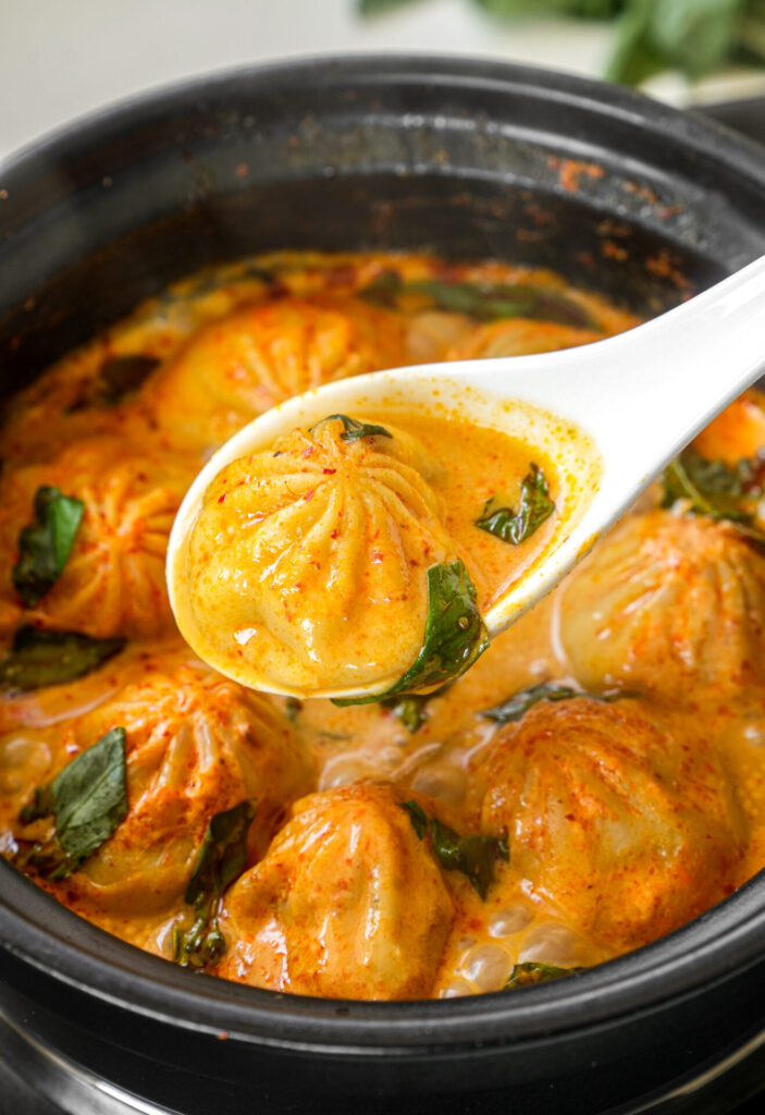 Soup dumplings in thai red curry sauce