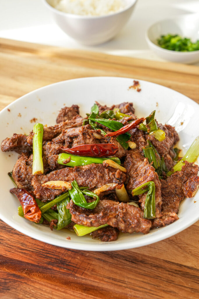 sacha beef stir fry with scallions served with rice