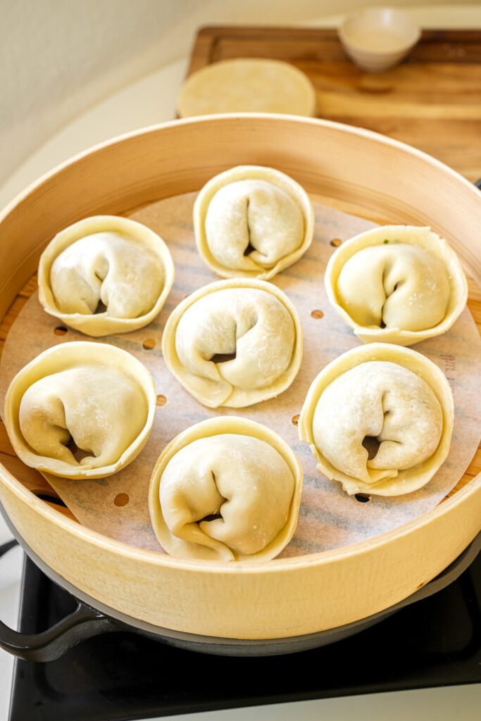 place korean kimchi mandu in steamer basket