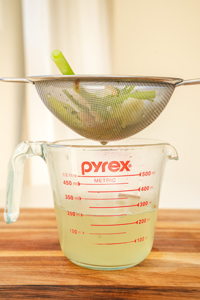 straining scallion ginger out of the water