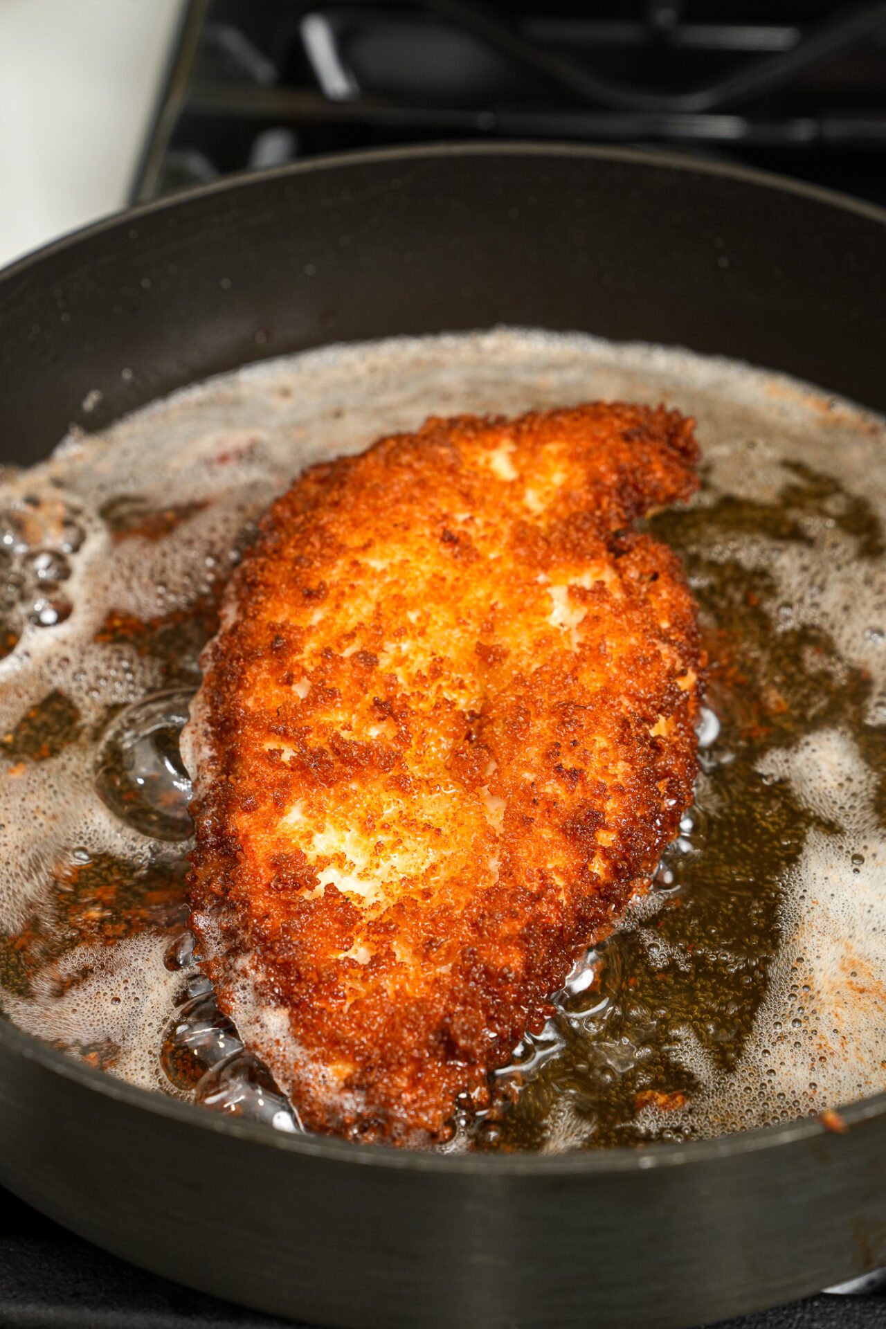 frying chicken breast for chicken katsu curry until both sides are golden brown and crispy