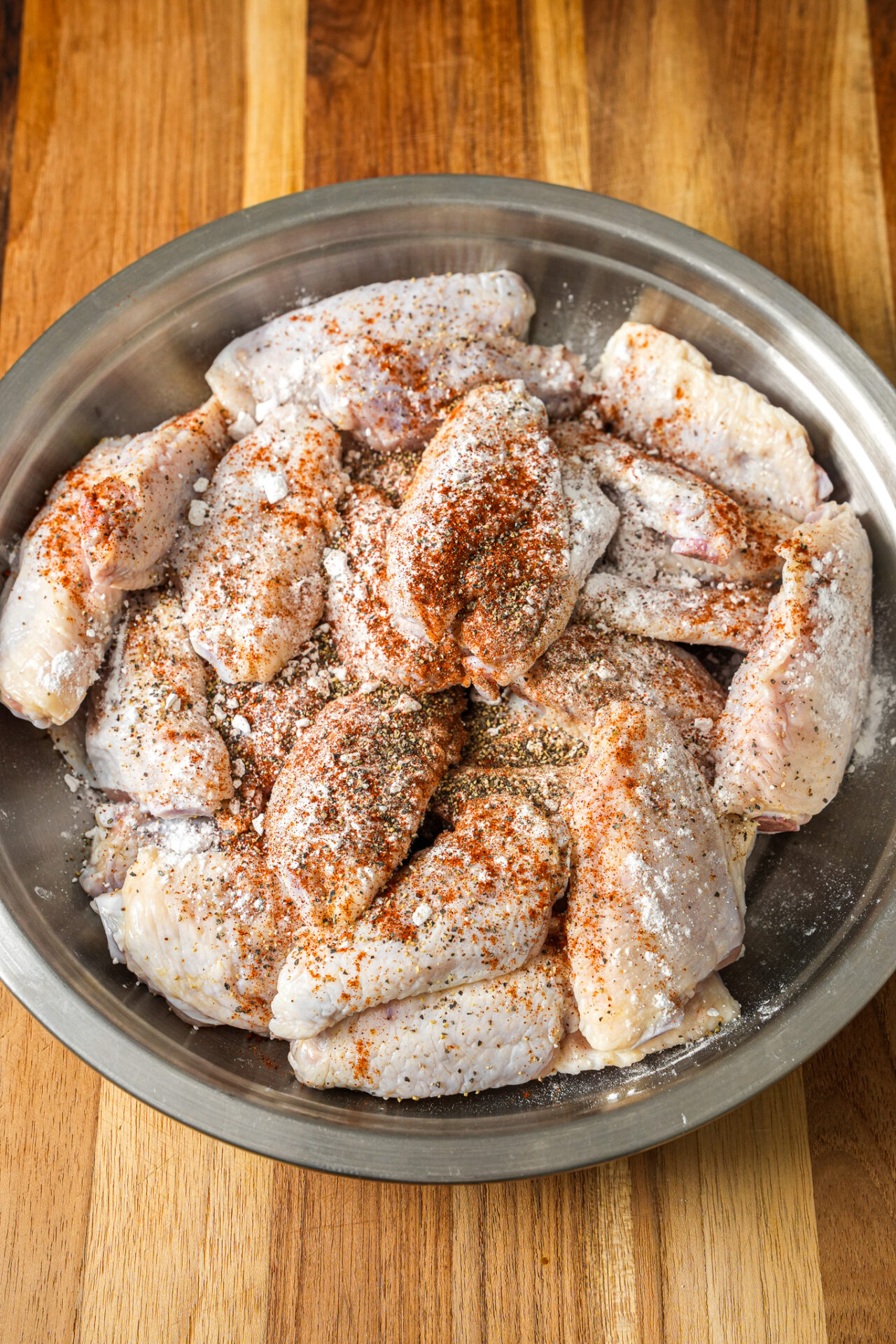 Season the chicken wings with baking powder, salt, pepper, and paprika