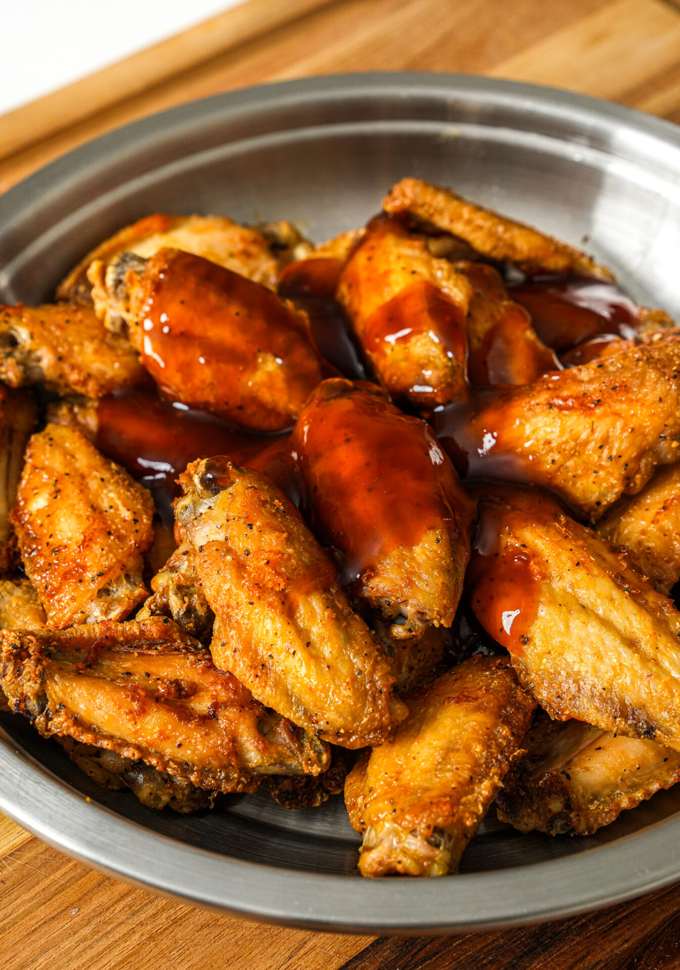 add sweet and sour sauce to the chicken wings and toss to combine