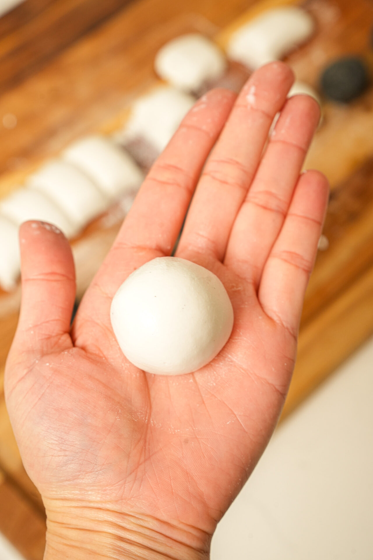 wrap the dough around black sesame filling and rollit into a round shape