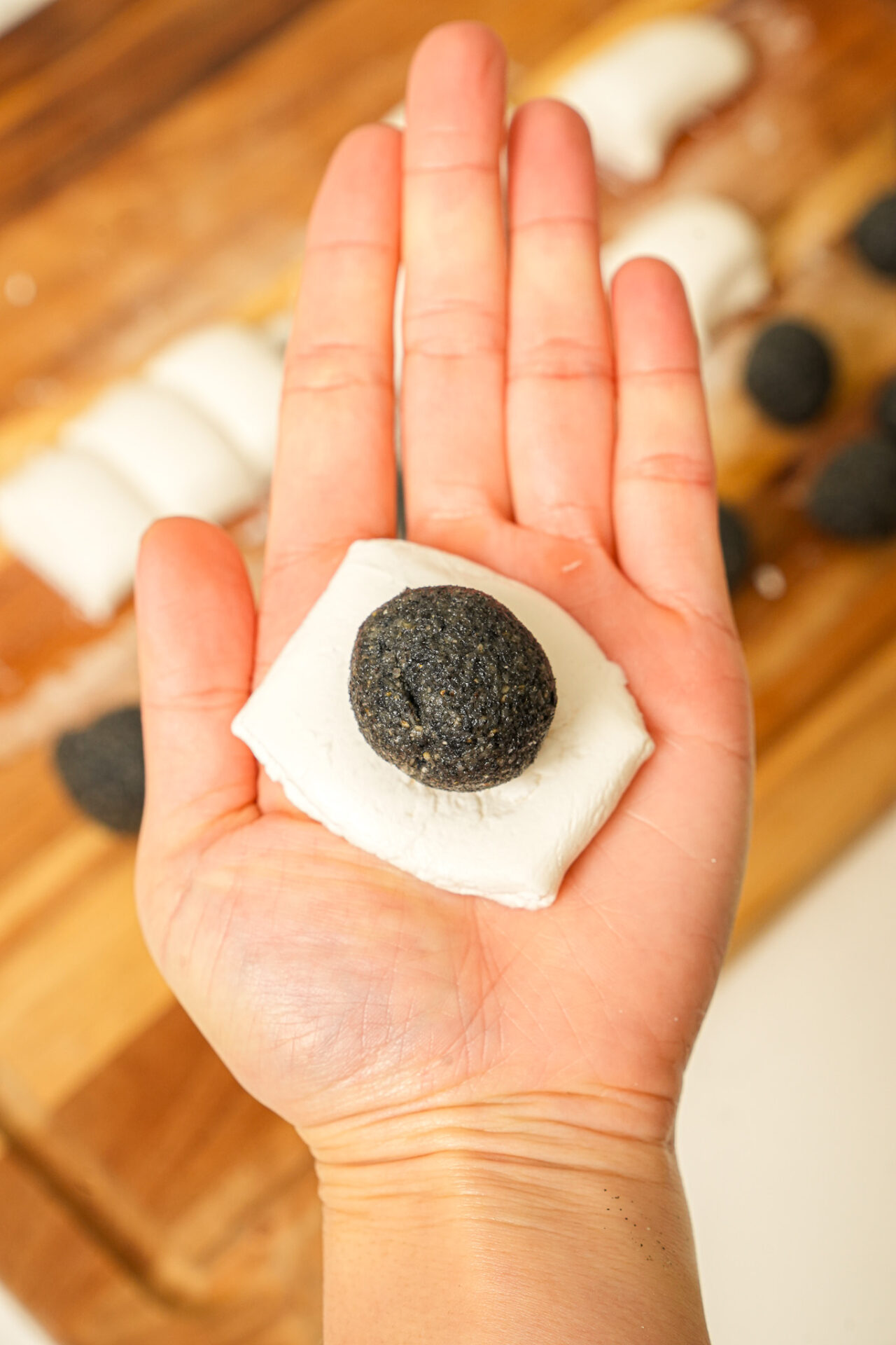 place sesame ball in the center of the dough for tang yuan