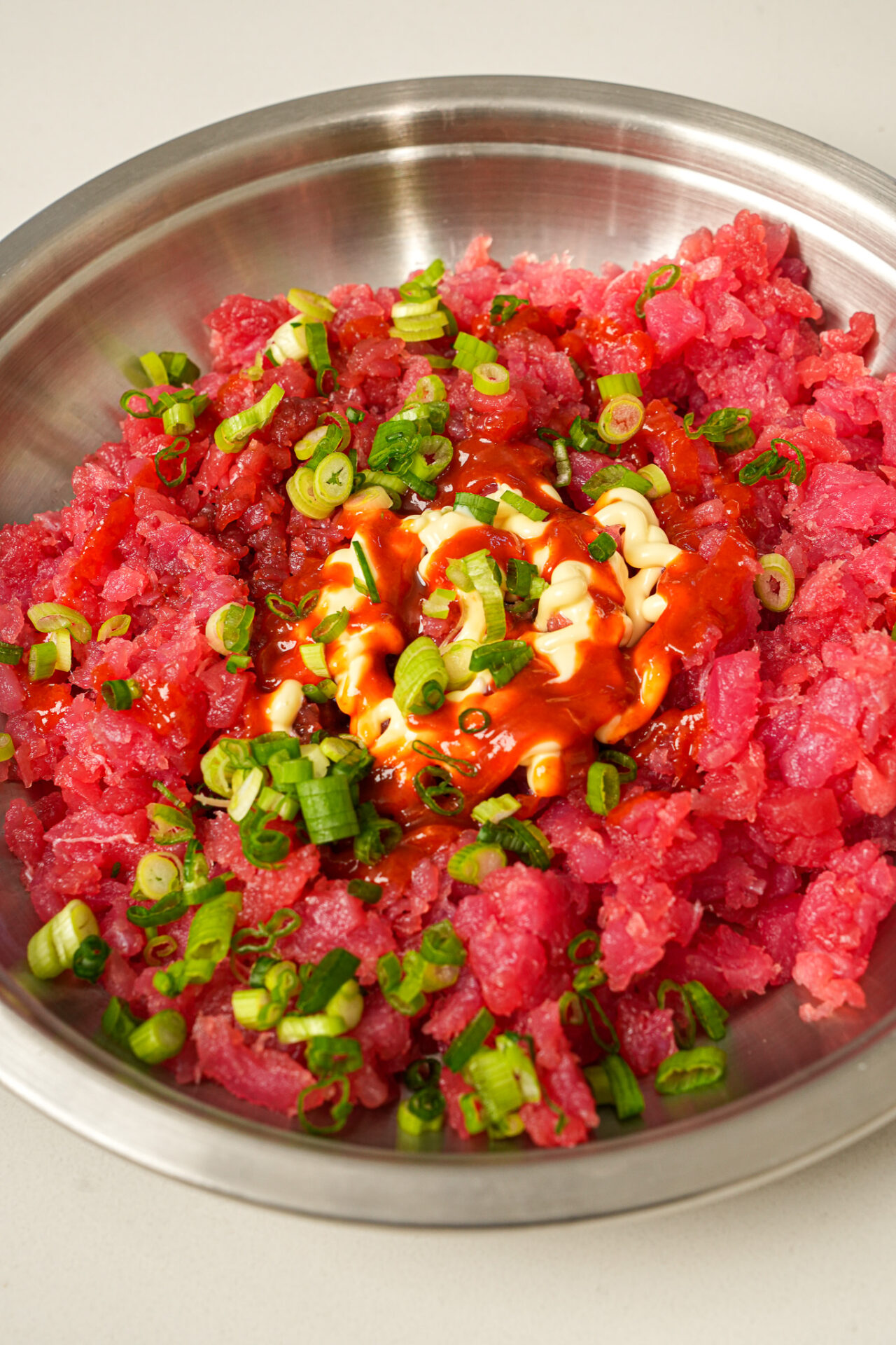 mix tuna with soy sauce, kewpie mayo, sriracha, sesame oil, and green onions